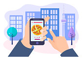 Pizza ordering via mobile application, the customer's hands holds the mobile phone with pizza on the screen on the city background. Vector illustration.