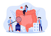 Tiny doctors checking and treating large intestine flat vector illustration. Cartoon inflammation in digestive system. Medicine and health concept