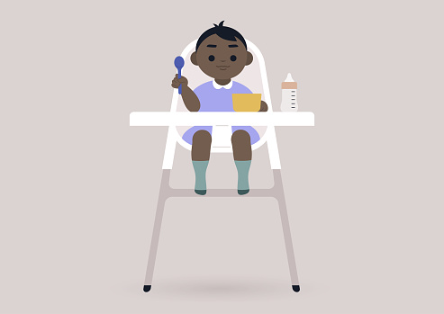 A toddler girl sitting in a kitchen baby chair, a lunchtime concept