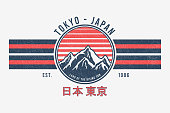 istock Tokyo, Japan t-shirt design with mountains and sun. Tee shirt graphics print with stripes, grunge and inscription in Japanese with the translation: Japan, Tokyo. Vector 1300861567