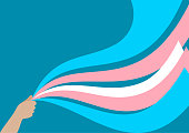 Illustration of a hand holding ribbons in the color of the transgender flag.