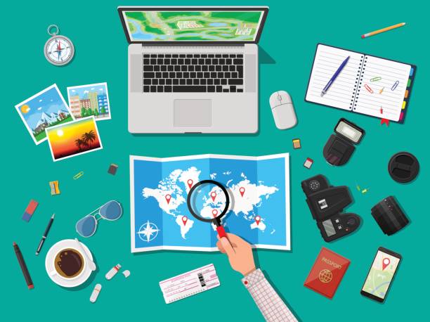 Traveler planning trip. Laptop pc and paper map. Photo camera and photos, notepad with pencil, compass, marker, coffee cup, eyeglasses, smarrphone. Traveler planning trip. Vector illustration in flat style exploration photos stock illustrations