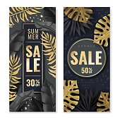 istock Tropical leaves vertical banners. Two vertical banners with tropical leaves in gold and dark colors. Frame cards. The intertwining golden leaves. Vector illustration 1370462713