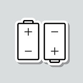 istock Two batteries. Icon sticker on gray background 1412841402