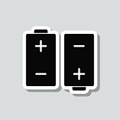 istock Two batteries. Icon sticker on gray background 1413972529