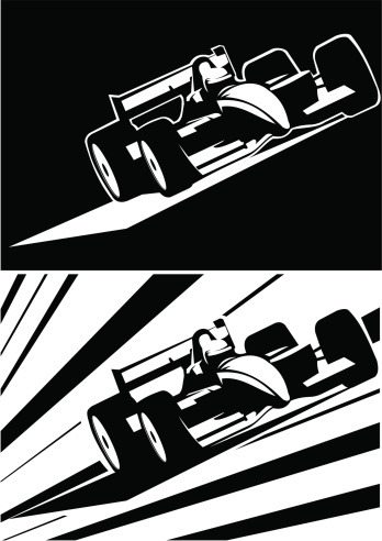 Two black and white formula one cars running