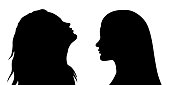 Vector black silhouette of 2 women faces in profile. EPS 10
