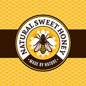 Vector honey label with bee on a honeycomb background.