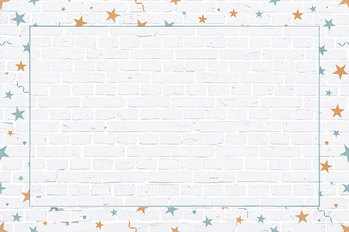 Vector Illustration of a Christmas theme photo or picture frame in pale blue and orange coloured elements  stars,  swirls, twirls, confetti surrounding/ making a border of a white grunge textured brick wall