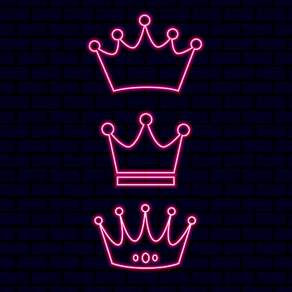 Vector neon crown. Set of different shapes of neon crowns. Pink neon light on a brick background. Brick wall.