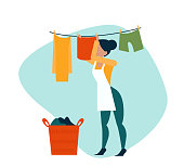 istock Vector of a woman hanging wet clothes out to dry 1317110332