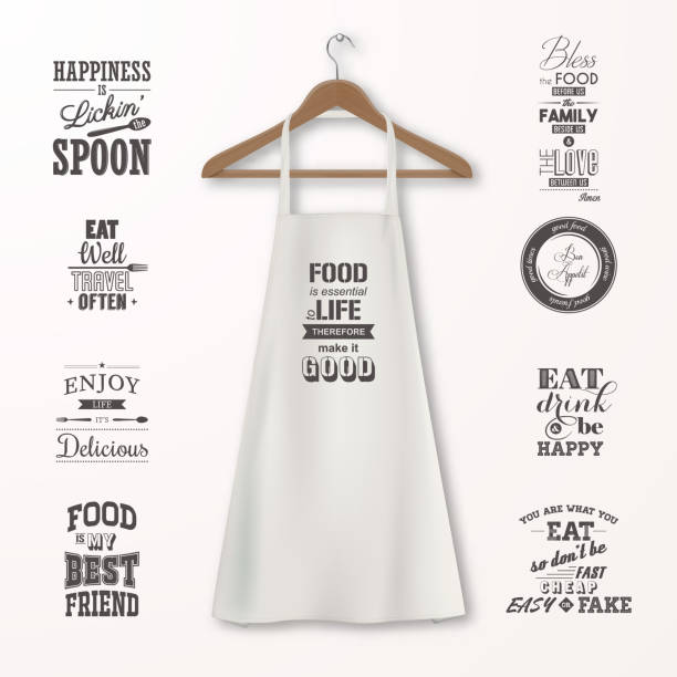 Vector realistic white cotton kitchen apron with clothes wooden hanger and quotes about food set closeup isolated on white. Design template, mock up for branding, graphics, advertising, printing Vector realistic white cotton kitchen apron with clothes wooden hanger and quotes about food set closeup isolated on white. Design template, mock up for branding, graphics, advertising, printing. apron stock illustrations
