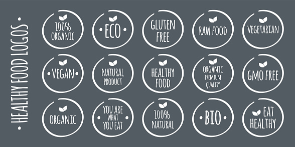 Vector white food logo on grey. 100% Organic, Eco, Gluten, GMO Free, Raw, Bio, Vegetarian, Vegan, Natural Product, Premium Quality, You are what you eat,  Eat Healthy symbols