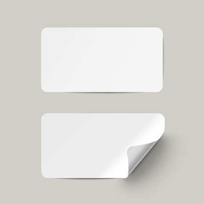 Vector white realistic paper adhesive stickers with curved corneron transparent background.