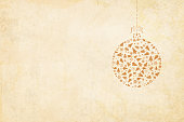 Grunge Vector Xmas background illustration. Vector Xmas background. Beige vintage paper with a suspended christmas bauble to the right in the frame. The bauble is hanging by a ribbon tied into a bow on the top. The bauble is made up  of christmas decoration items like X'Mas tree, snowflakes, balls, cones.  Ample copy space. Apt Christmas light coloured background in neutral earthy tone. Can also be used in gift wrapping sheets.