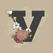 Detailed vintage floral line art plays up against a chunky letter drop cap.