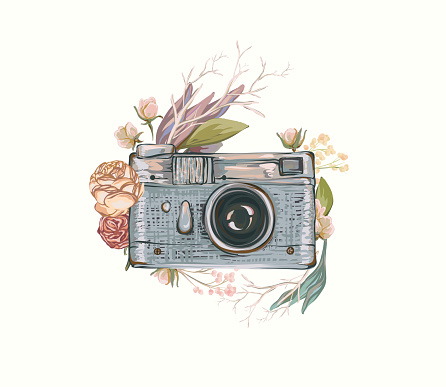 Vintage retro photo camera in flowers.