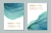istock Watercolor backgrounds with abstract teal ink waves and metallic splashes on a white. 1313433165