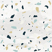 A seamless modern terrazzo pattern with a textured background.