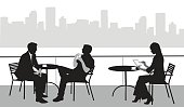 A vector silhouette illustration of a young woman using a tablet while sitting at an outdoor cafe patio with two other business men sitting at another table.  The patio overlooks a body of water with a city scape in the background.
