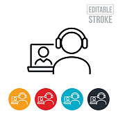 An icon of two business people using a laptop to conduct a webinar. The icon includes editable strokes or outlines using the EPS vector file.