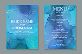 istock Wedding invitation with blue watercolor waves or fluid art in alcohol ink style with golden glitter. 1289349632