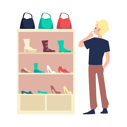 White male standing at shoes shop before shoe rack with woman's shoes, bags and boots.