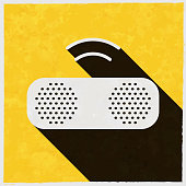 istock Wireless speaker. Icon with long shadow on textured yellow background 1401059045