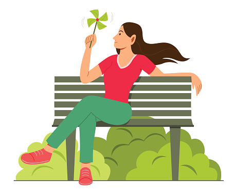 Woman Enjoy the Paper Windmill While Sit on Bench in Garden.
