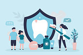 istock Woman holding big toothbrush with paste. Various tools for maintaining oral hygiene. Dentist explains hygiene rules to children 1348669757