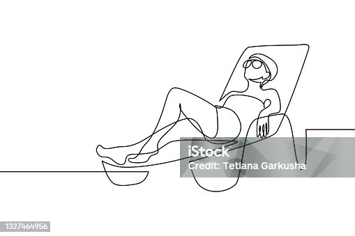 istock Woman relaxing on a lounge chair 1327464956