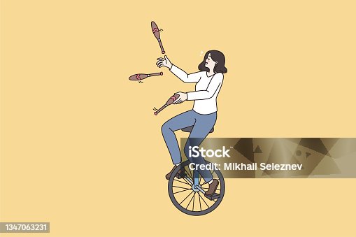 istock Woman ride unicycle juggle with skittles 1347063231