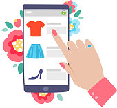 Woman shopping online concept. Mobile phone or tablet with woman's hand browsing web site. Flowers background.