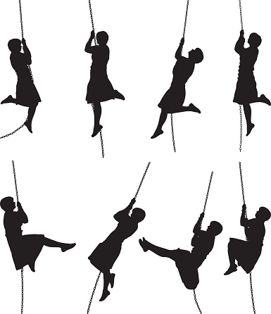 Woman silhouette swinging on a rope