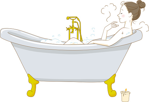 Woman taking a bath relaxing in the bathtub