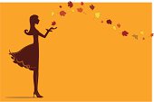 A girl with autumn leaves flying around her.