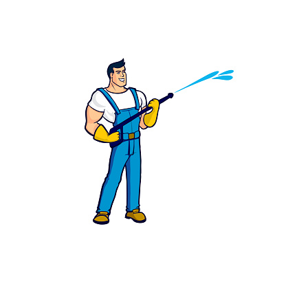 A worker in a blue overalls holds in his hands a device for cleaning houses under strong pressure of water A strong-built brunette cleaner with yellow gloves is pictured at work.Wet cleaning isolated