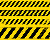 istock Yellow grunge warning sign lines symbol 1345877121