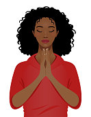 Young black woman praying portrait isolated on a white background.