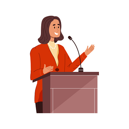 Young businessman or politician woman speaks into microphone standing behind podium