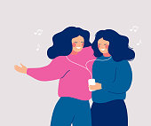 Young cheerful women sharing their earphone and listening to music with mobile phone and dancing. Flat vector characters illustration in hand drawn style.