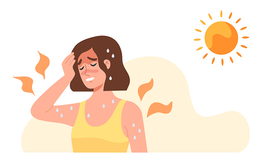Young woman at outdoor with hot  sun light has a risk to have Heat stroke. Symptoms such as high body temperature, sweat, perspire, headache, red skin, dehydration.