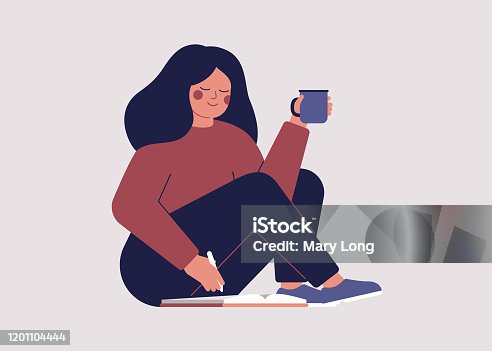 istock Young woman goes through her datebook in the morning and plans her day 1201104444