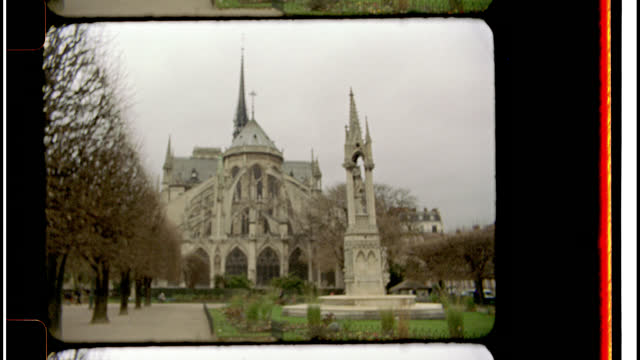 16mm Bolex film footage. View of the Notre Dame Cathedral flying buttresses from the back courtyard.