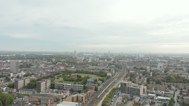 4k Aerial Stunning Overview in East London While Train Goes By on a Bright Day