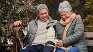 istock 4k video footage of a happy senior couple playing with their pets while relaxing in a garden 1354195962