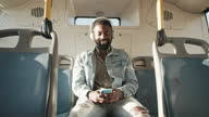 istock 4k video footage of a young man using a smartphone and headphones while traveling on a bus 1321416779