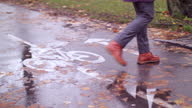 istock a man crossing a wet bike road 1285299892