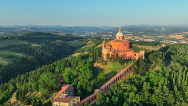 Aerial Drone Sunrise Scene of Sanctuary of the Madonna di San Luca chapel existed on the hill for about a thousand years with a road now leads up to the sanctuary, it along a 3.8 km monumental roofed arcade (Portico di San Luca) consisting of 666 arches