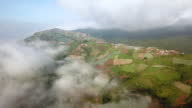 istock Aerial shot small village on the mountain with cloud and sky 1396617071